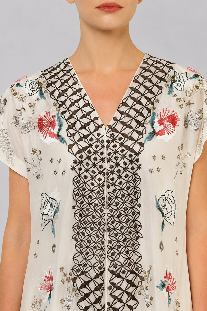 Ivory Embroidered Dress With Geometric Detailing And Layered Flared Hem.