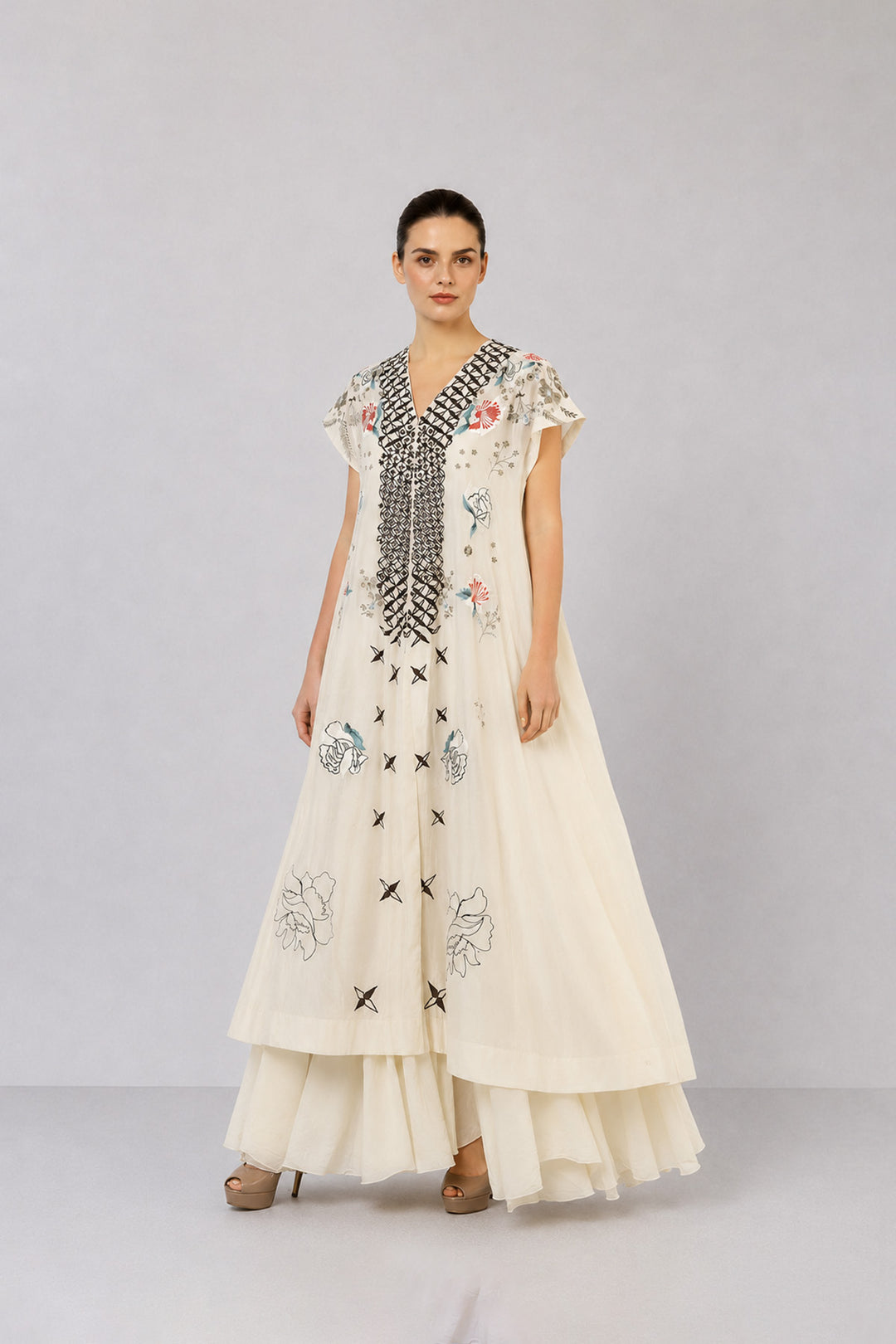 Ivory Embroidered Dress With Geometric Detailing And Layered Flared Hem.