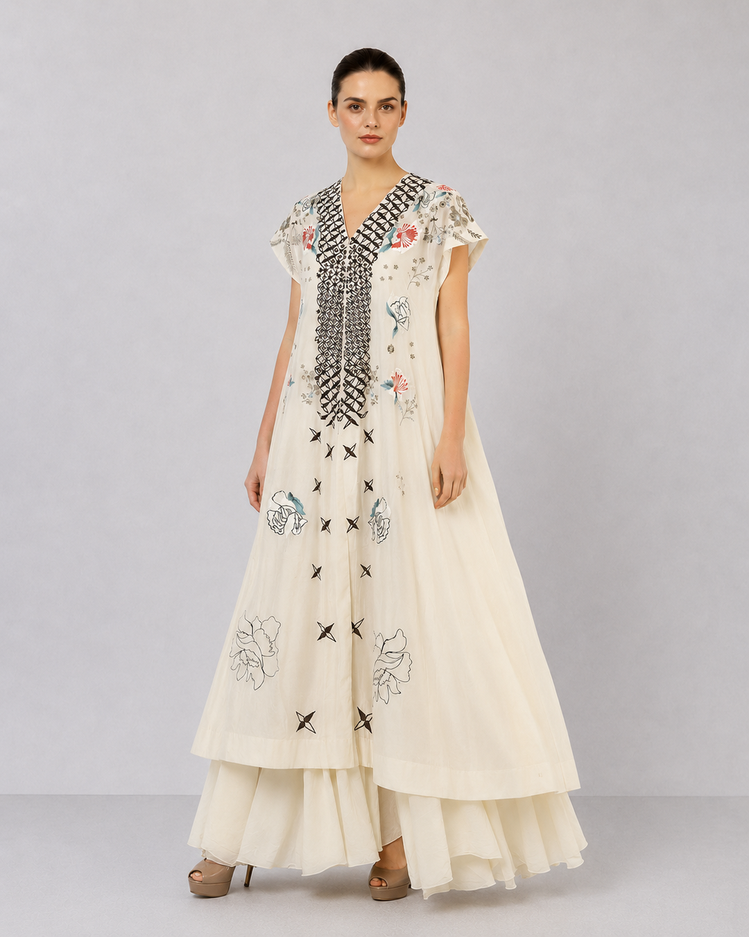Ivory Embroidered Dress With Geometric Detailing And Layered Flared Hem.