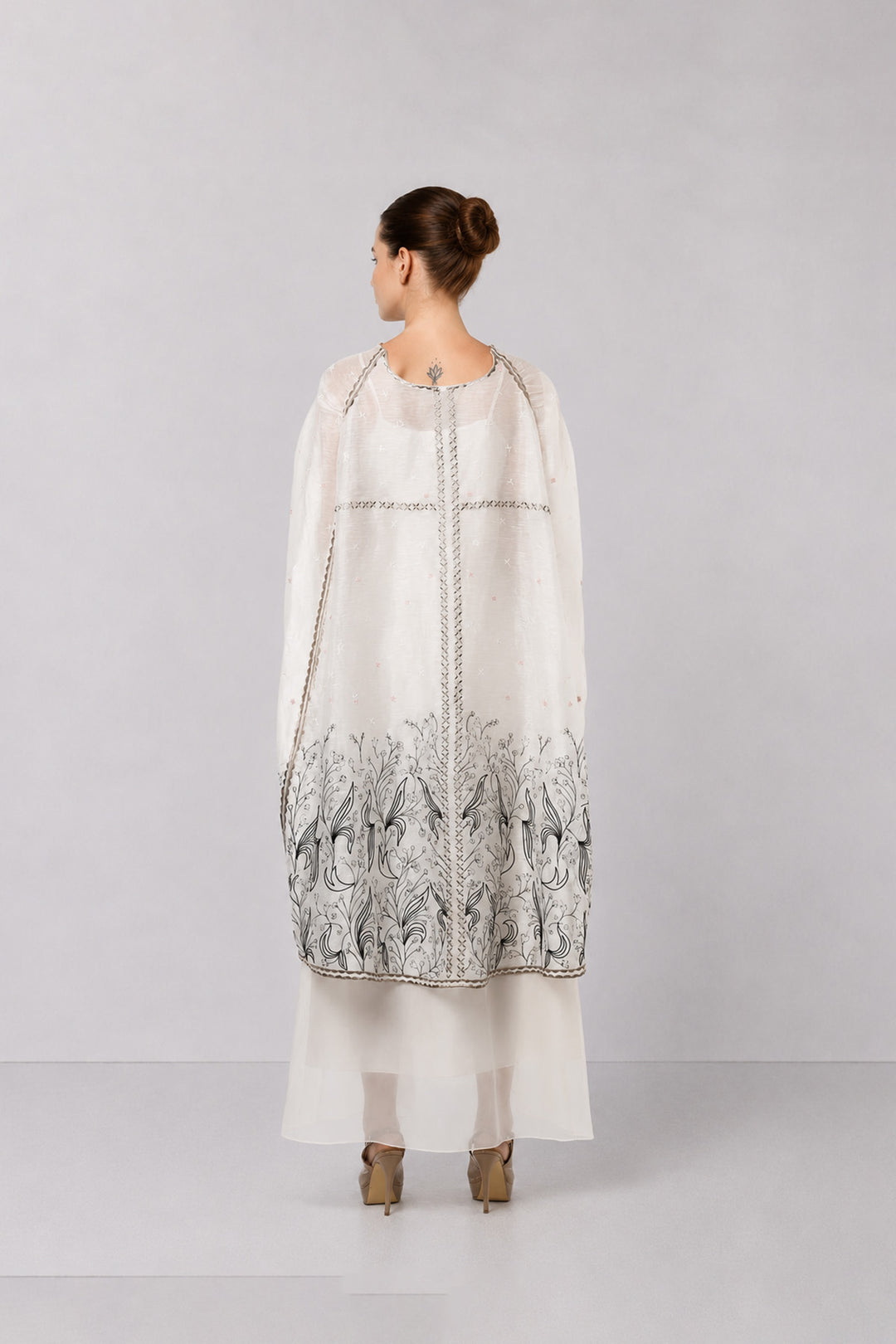 Ivory Embroidered Cape Dress With Sheer Layering And Floral Motifs.