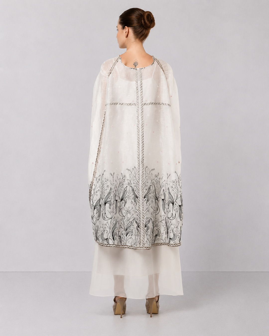 Ivory Embroidered Cape Dress With Sheer Layering And Floral Motifs.