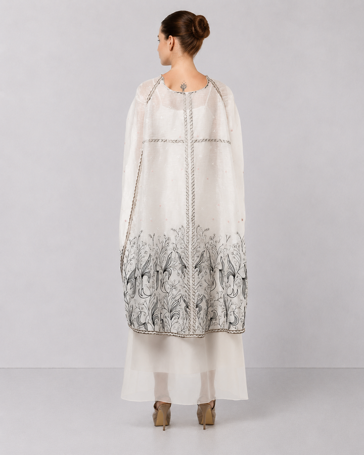 Ivory Embroidered Cape Dress With Sheer Layering And Floral Motifs.