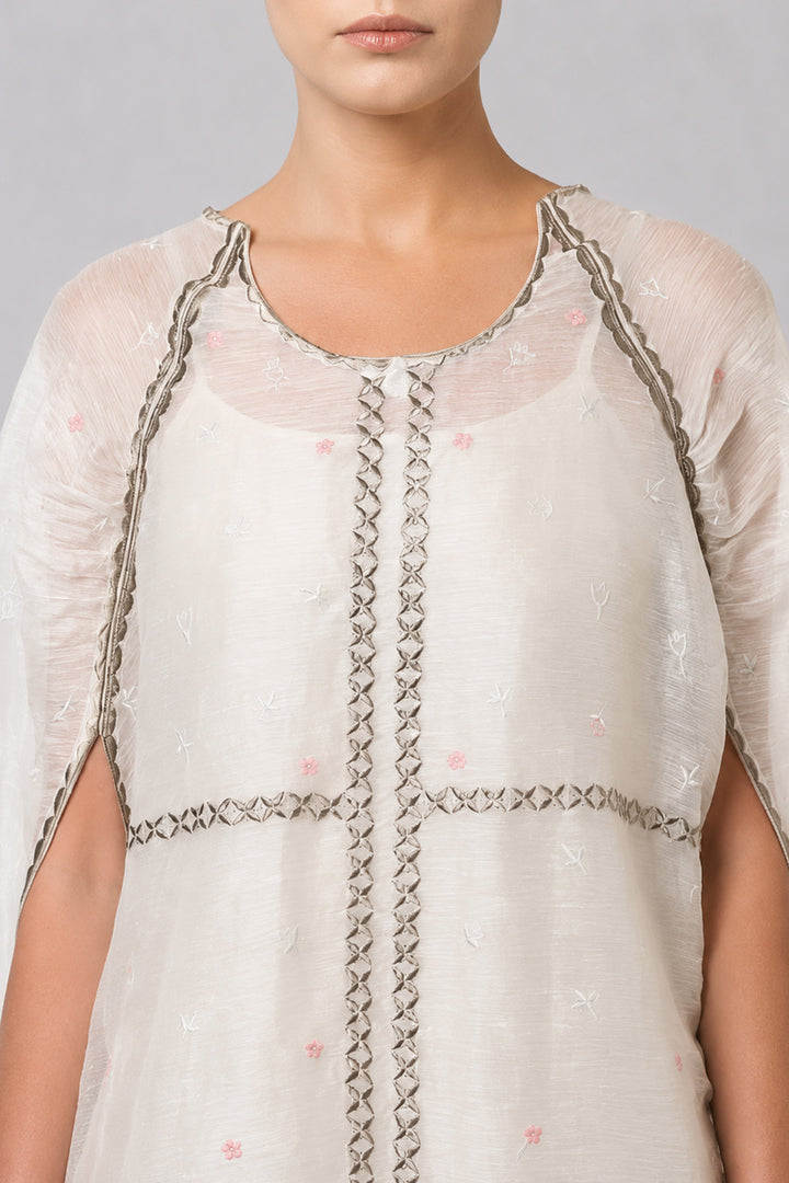 Ivory Embroidered Cape Dress With Sheer Layering And Floral Motifs.