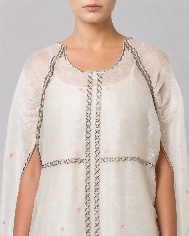 Ivory Embroidered Cape Dress With Sheer Layering And Floral Motifs.