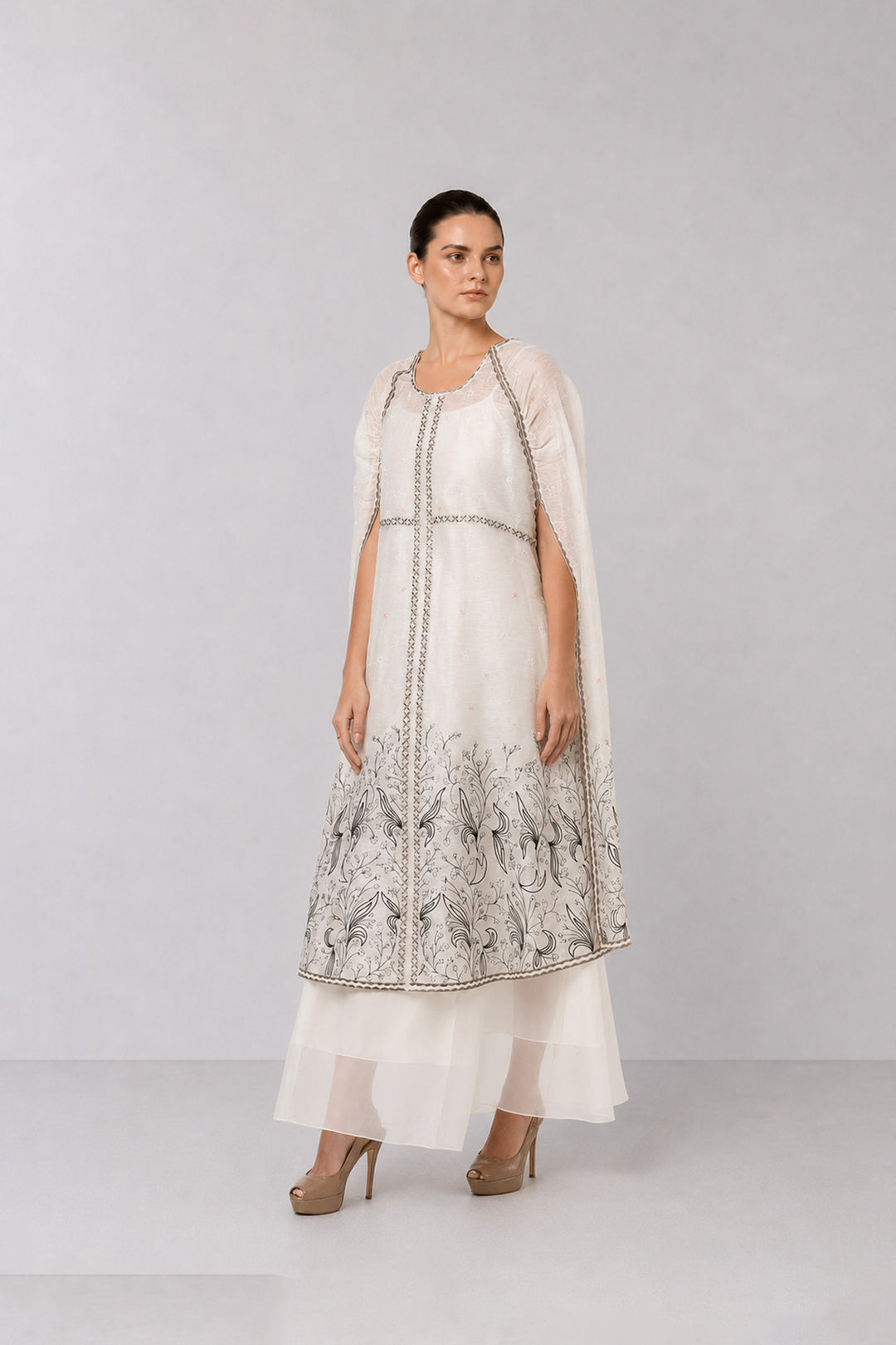 Ivory Embroidered Cape Dress With Sheer Layering And Floral Motifs.