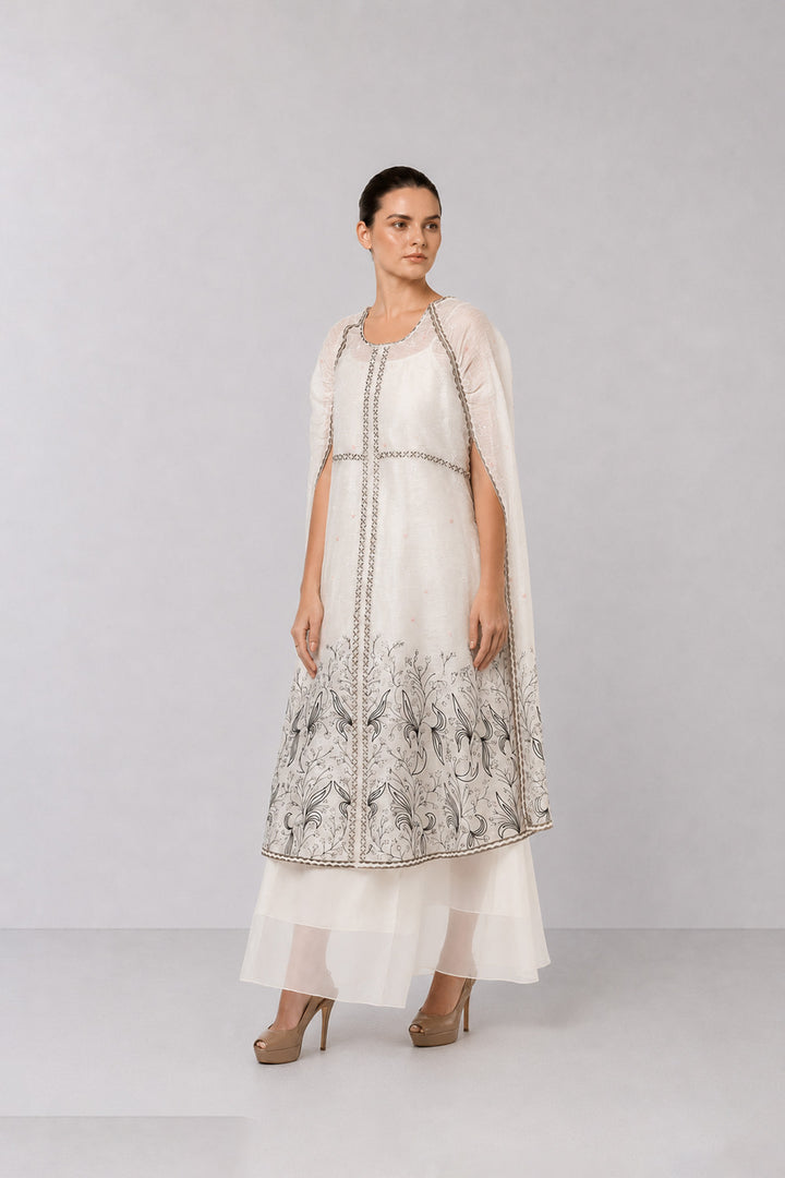 Ivory Embroidered Cape Dress With Sheer Layering And Floral Motifs.