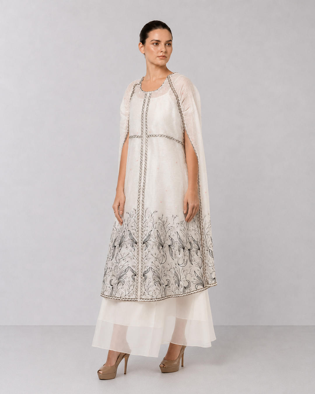 Ivory Embroidered Cape Dress With Sheer Layering And Floral Motifs.