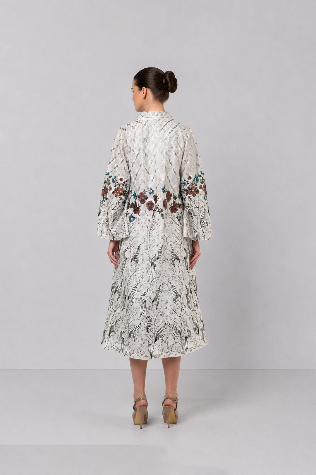 Ivory Long Jacket Paired With Crop Top &amp; Skirt Featuring Trench Overlay With Botanical Artwork.