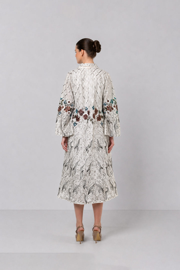 Ivory Long Jacket Paired With Crop Top &amp; Skirt Featuring Trench Overlay With Botanical Artwork.