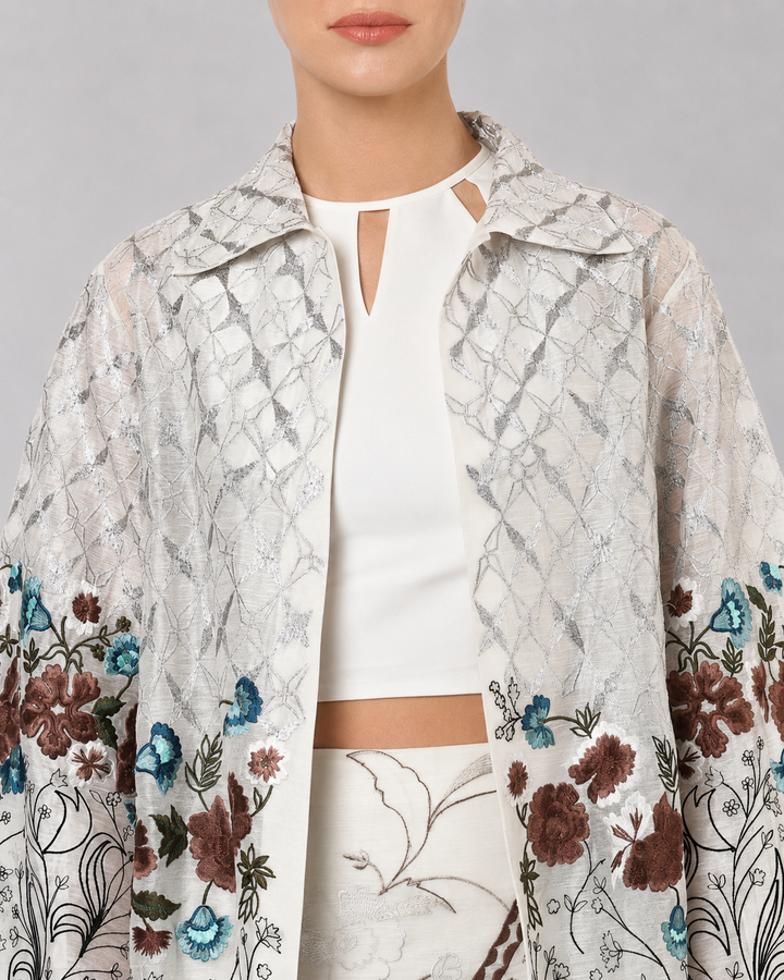 Ivory Long Jacket Paired With Crop Top &amp; Skirt Featuring Trench Overlay With Botanical Artwork.