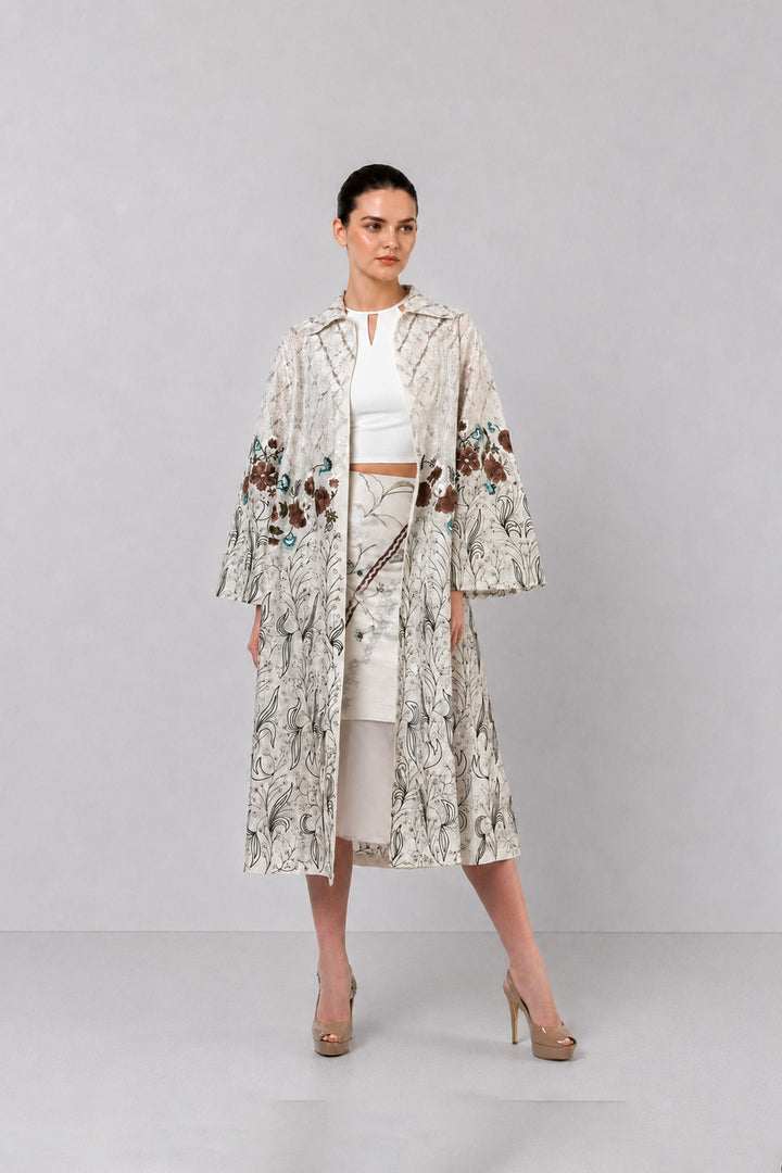 Ivory Long Jacket Paired With Crop Top &amp; Skirt Featuring Trench Overlay With Botanical Artwork.