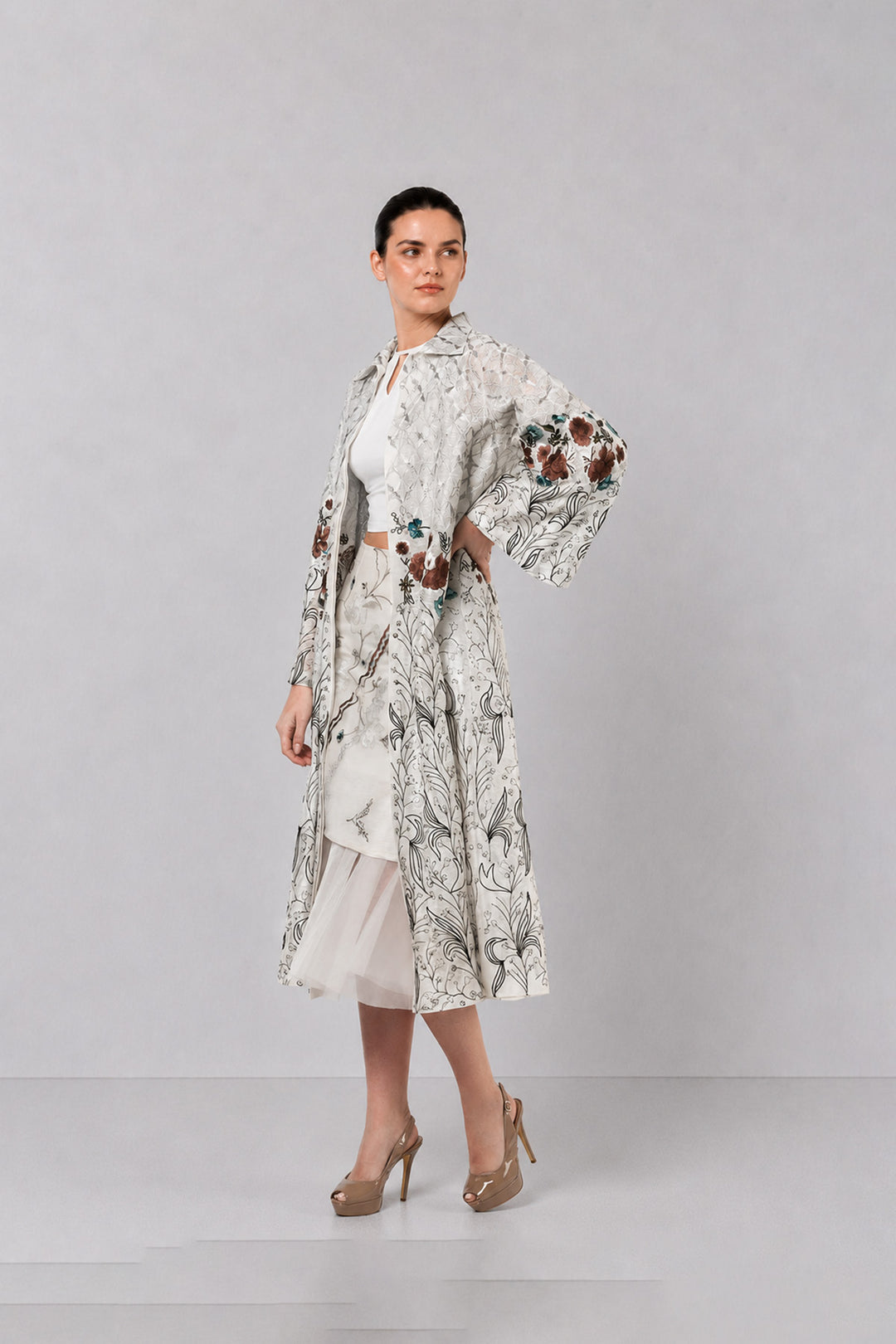 Ivory Long Jacket Paired With Crop Top &amp; Skirt Featuring Trench Overlay With Botanical Artwork.