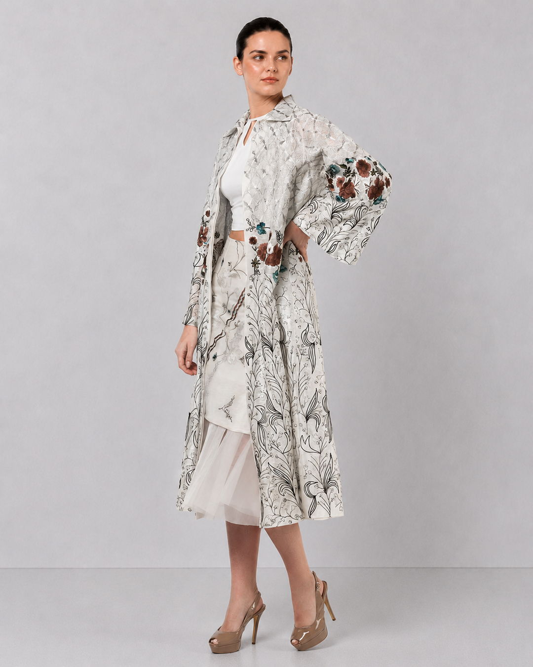 Ivory Long Jacket Paired With Crop Top &amp; Skirt Featuring Trench Overlay With Botanical Artwork.