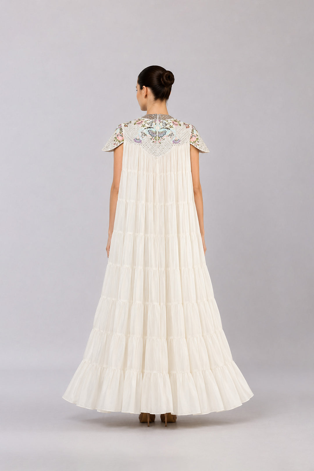 Ivory Tiered Gown With Embroidered Yoke And Cascading Ruffle Hem.
