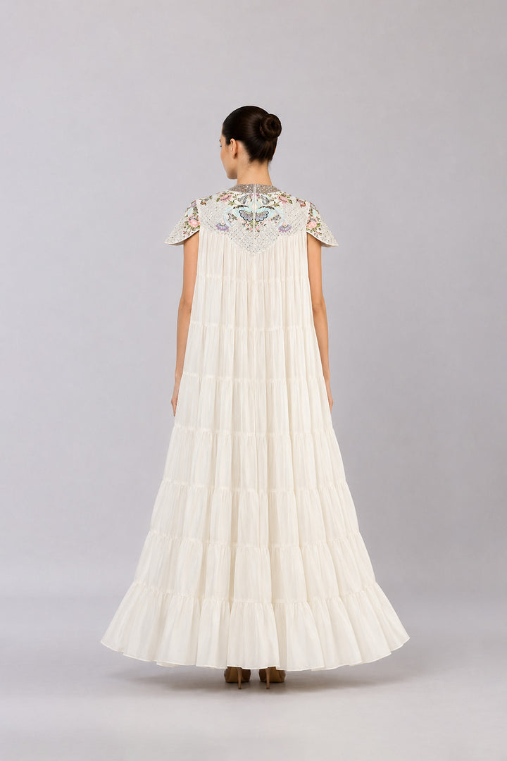 Ivory Tiered Gown With Embroidered Yoke And Cascading Ruffle Hem.