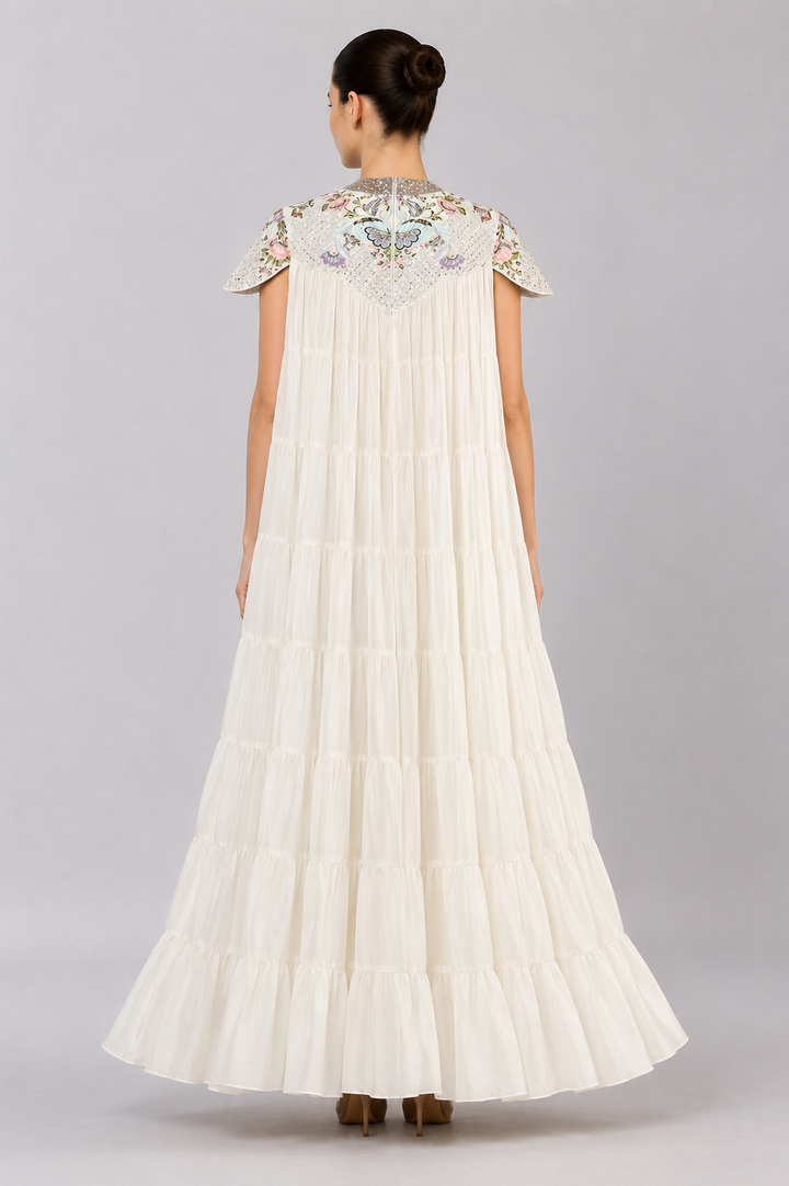 Ivory Tiered Gown With Embroidered Yoke And Cascading Ruffle Hem.