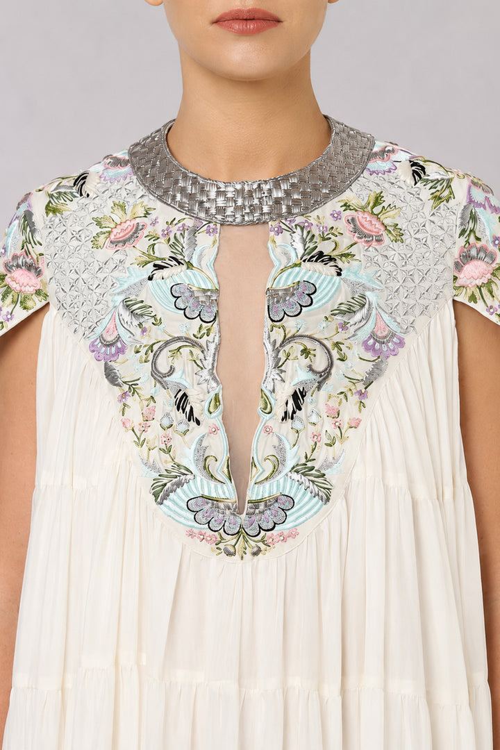 Ivory Tiered Gown With Embroidered Yoke And Cascading Ruffle Hem.