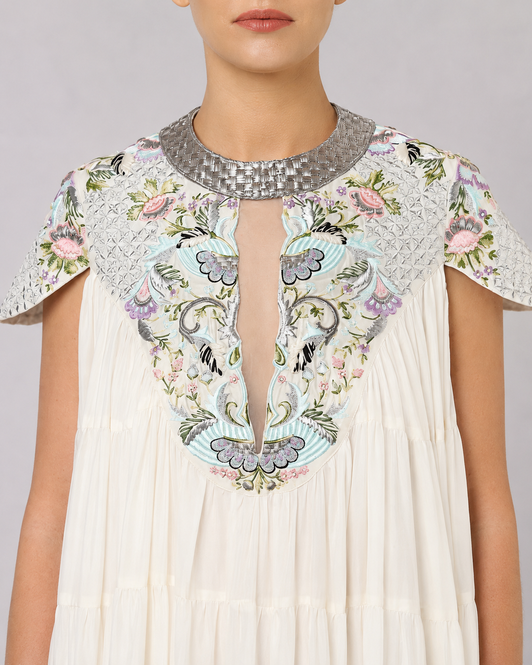 Ivory Tiered Gown With Embroidered Yoke And Cascading Ruffle Hem.