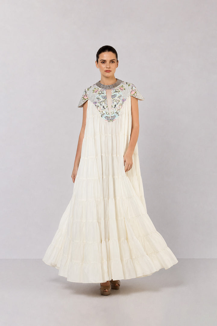 Ivory Tiered Gown With Embroidered Yoke And Cascading Ruffle Hem.