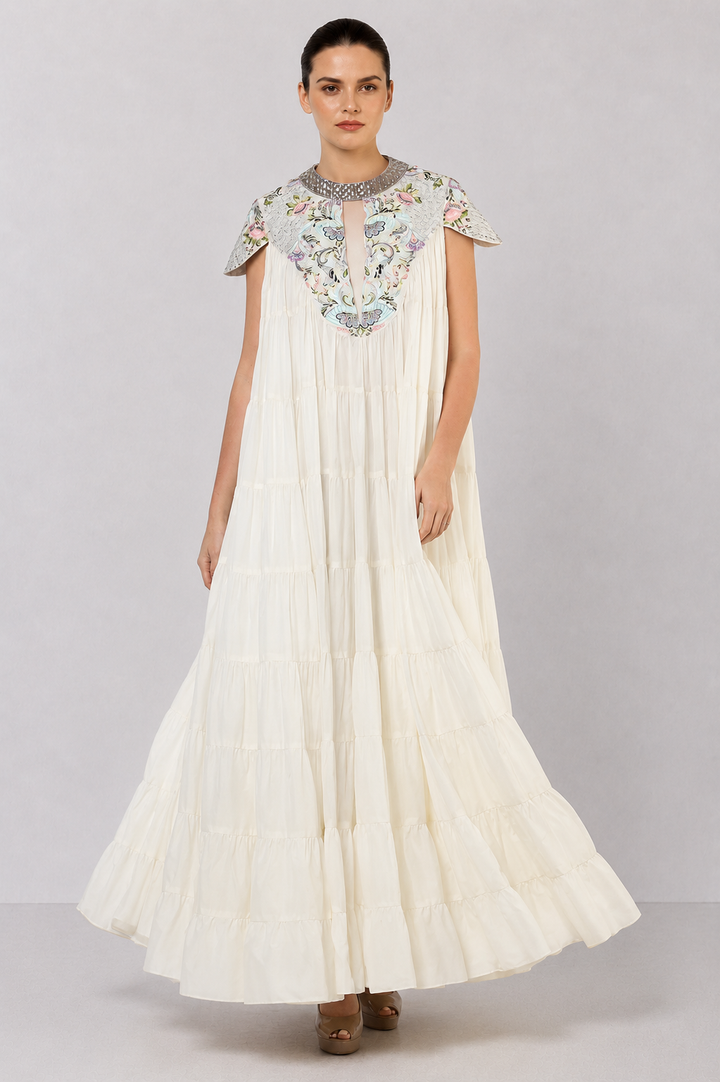 Ivory Tiered Gown With Embroidered Yoke And Cascading Ruffle Hem.