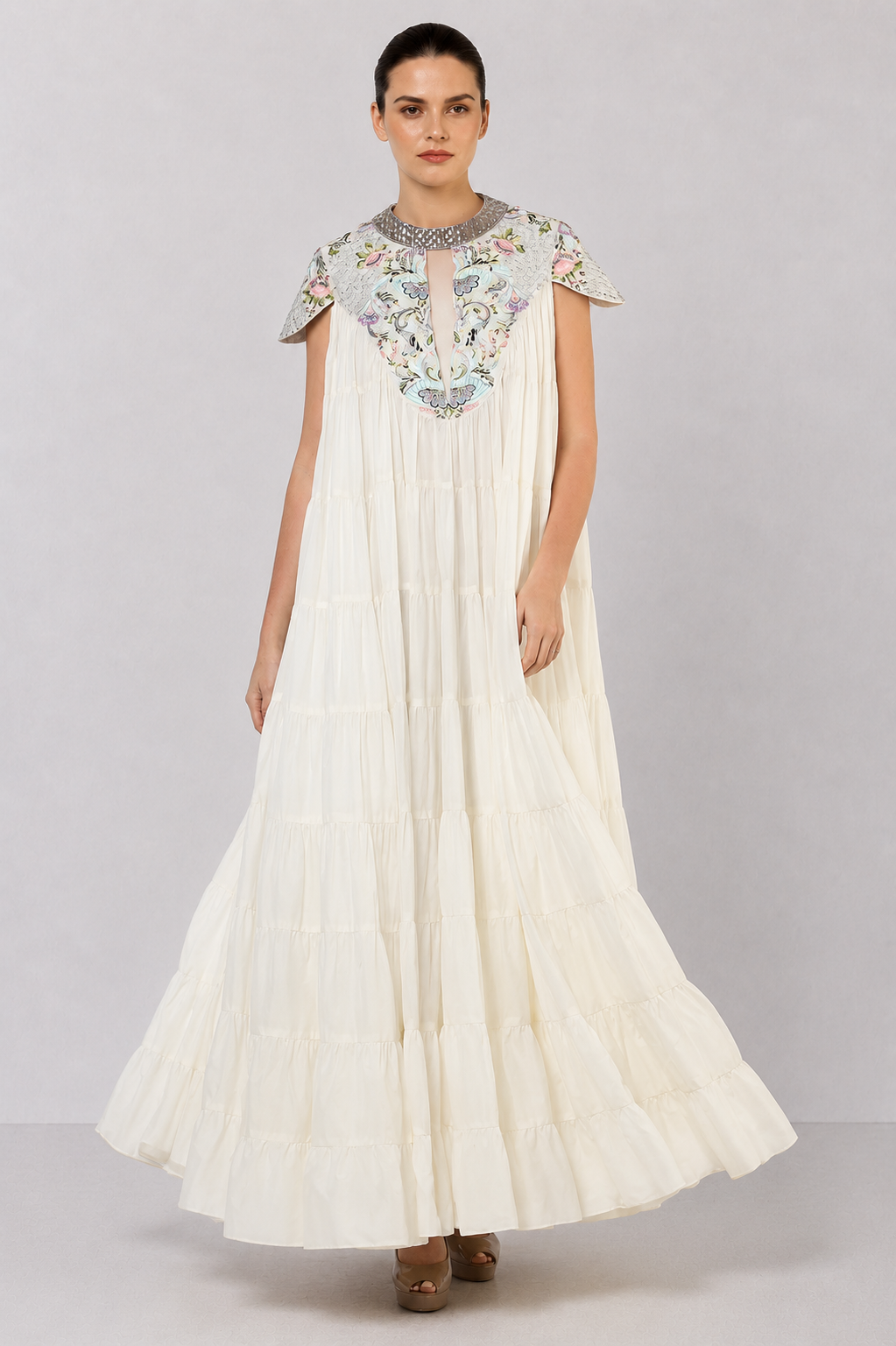Ivory tiered gown with embroidered yoke and cascading ruffle hem.
