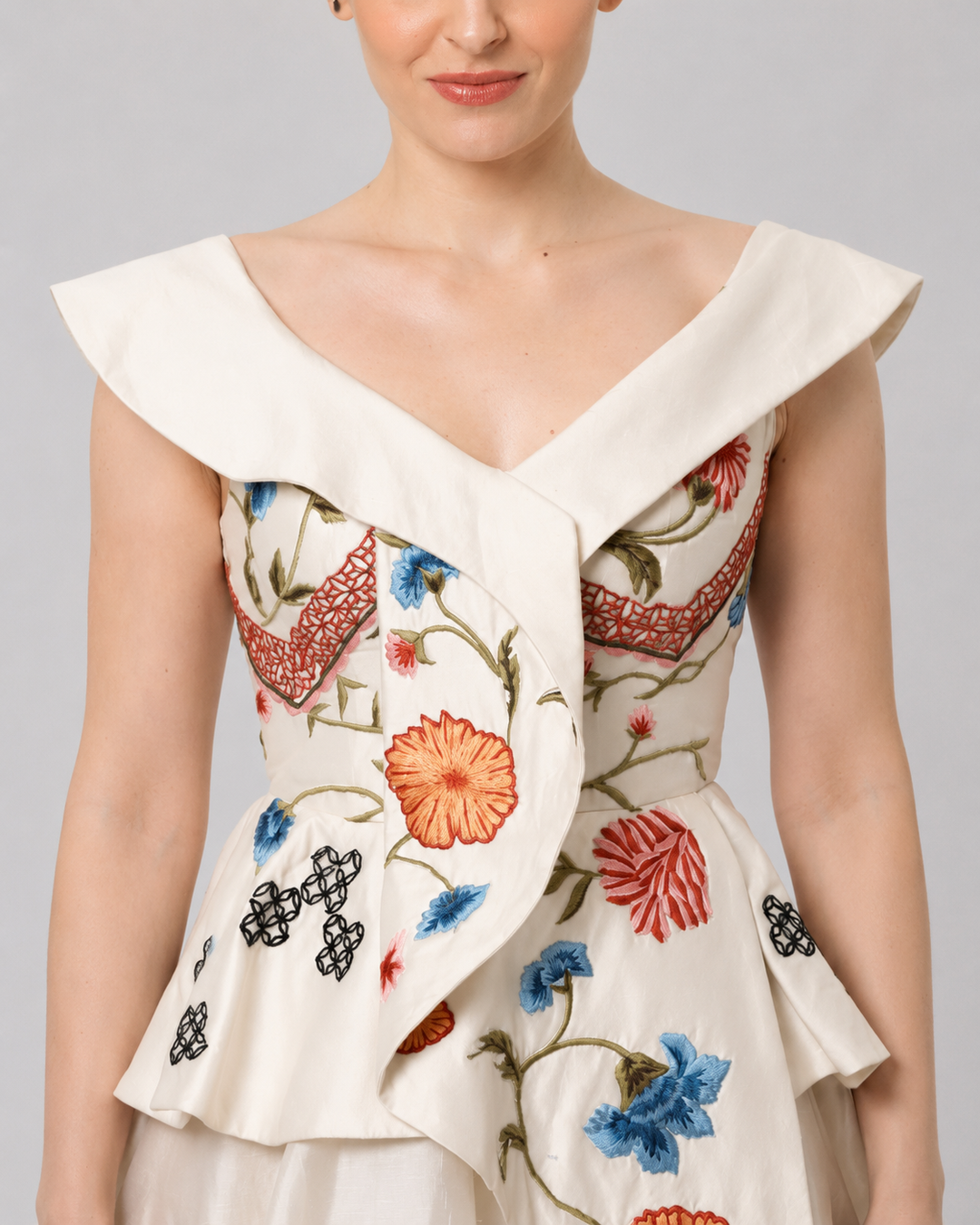 Ivory Floral Embroidered Peplum Gown With An Off-Shoulder Neckline And Voluminous Drape.