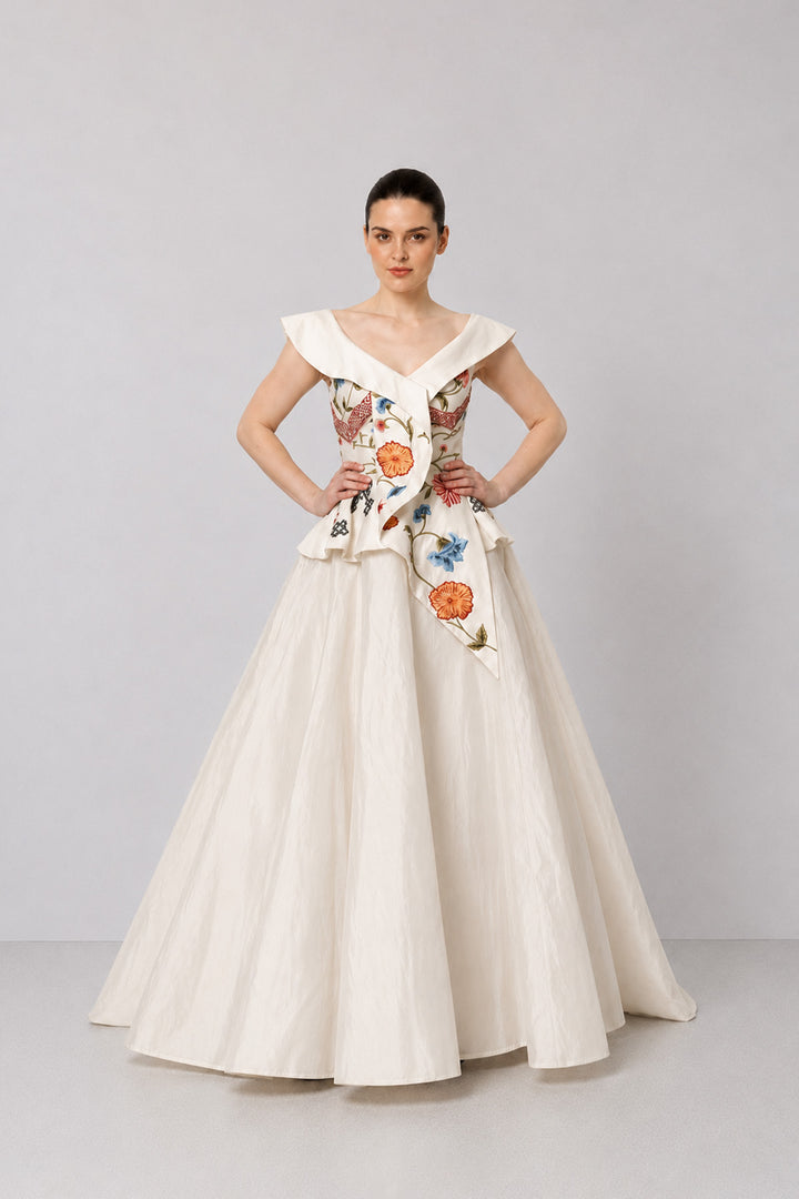 Ivory Floral Embroidered Peplum Gown With An Off-Shoulder Neckline And Voluminous Drape.