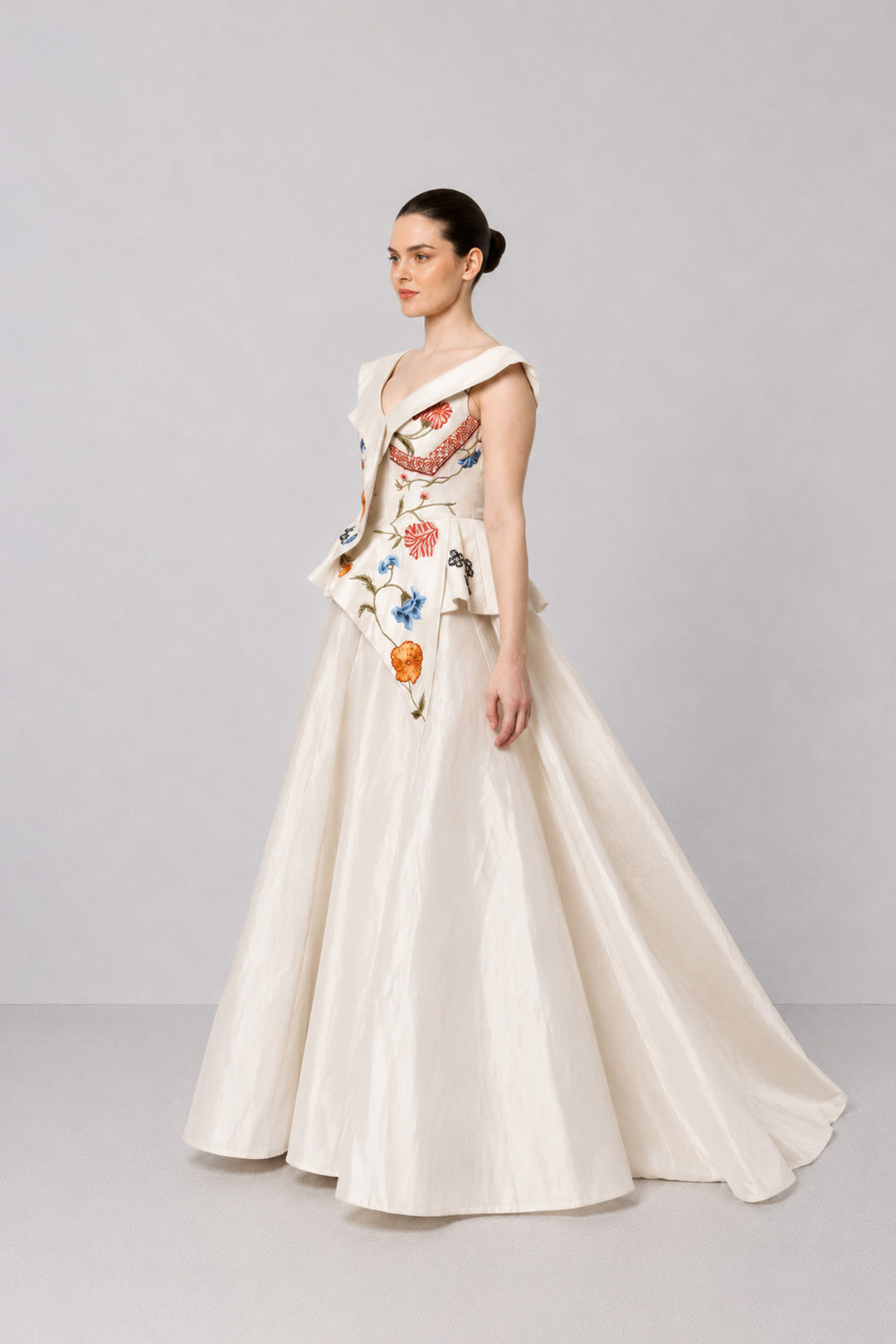 Ivory Floral Embroidered Peplum Gown With An Off-Shoulder Neckline And Voluminous Drape.