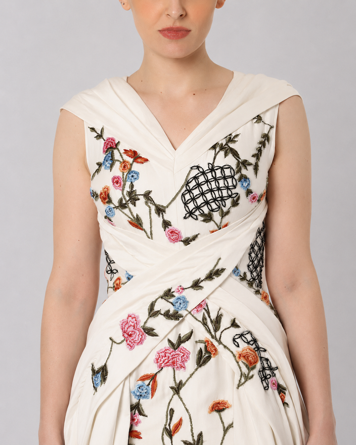 Ivory Embroidered Crossover Gown With Floral Artwork And Dramatic Side Drapes.