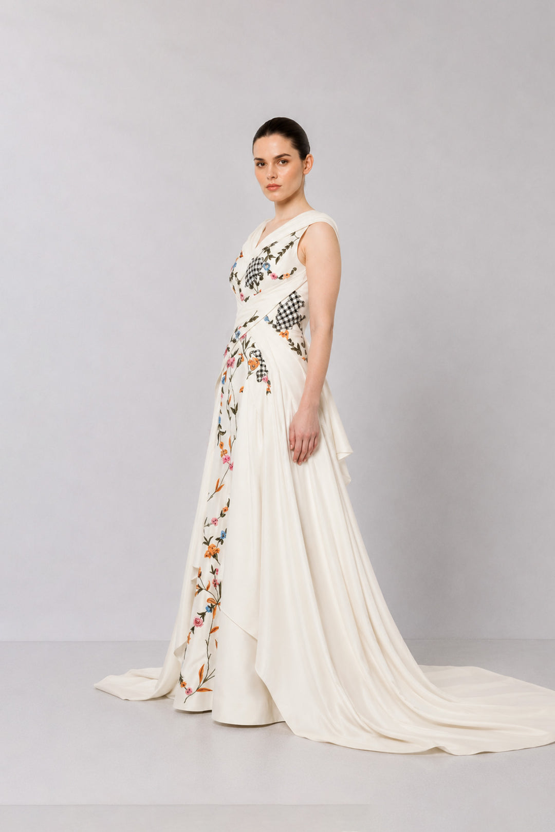 Ivory Embroidered Crossover Gown With Floral Artwork And Dramatic Side Drapes.