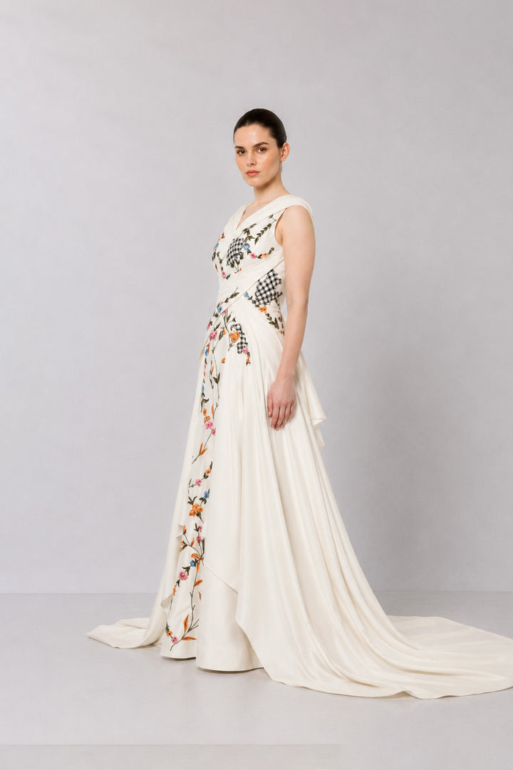 Ivory Embroidered Crossover Gown With Floral Artwork And Dramatic Side Drapes.