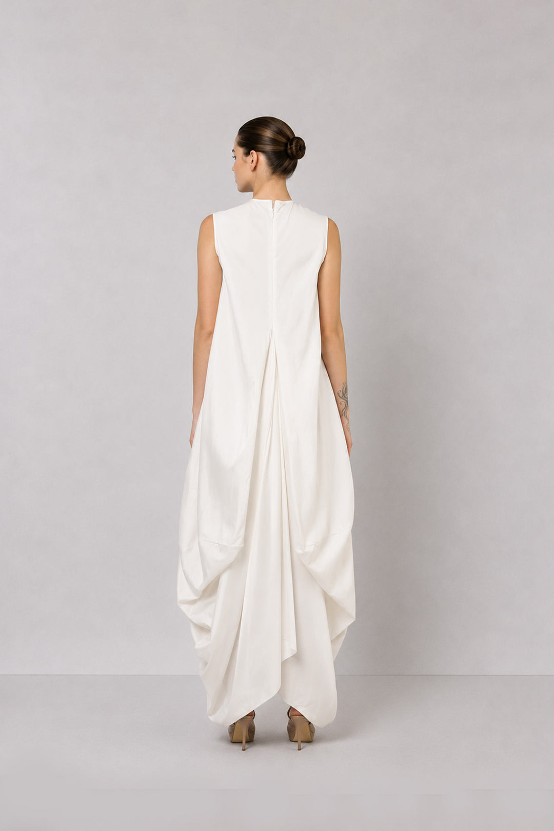 Ivory layered dress with embroidered artwork and statement overcoat.