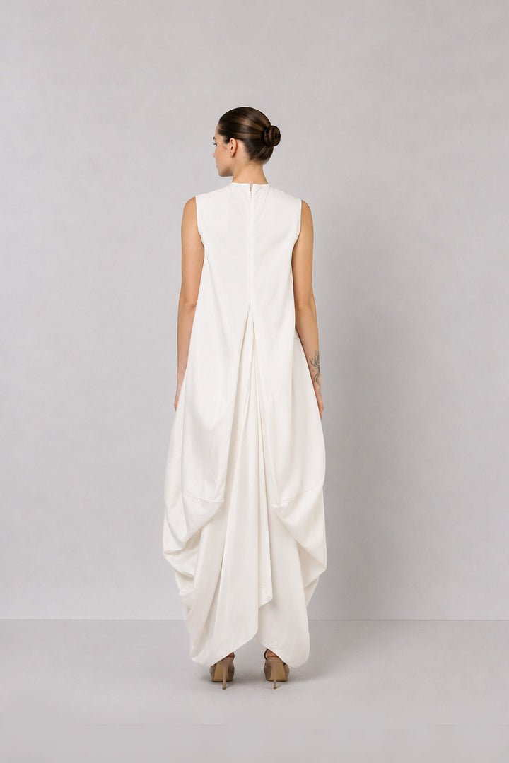 Ivory layered dress with embroidered artwork and statement overcoat.