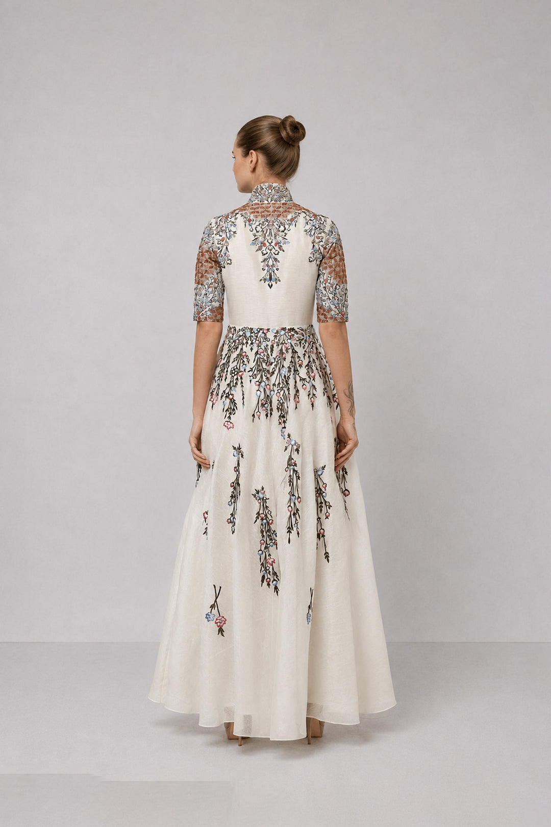 Ivory Embroidered Gown With Structured High Neck And Cascading Floral Motifs.