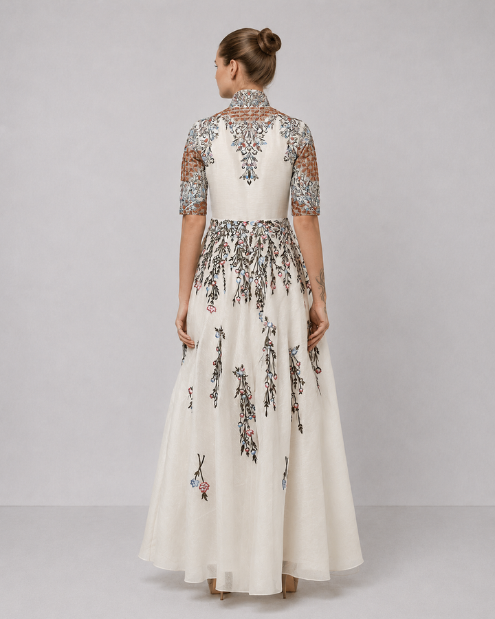 Ivory Embroidered Gown With Structured High Neck And Cascading Floral Motifs.