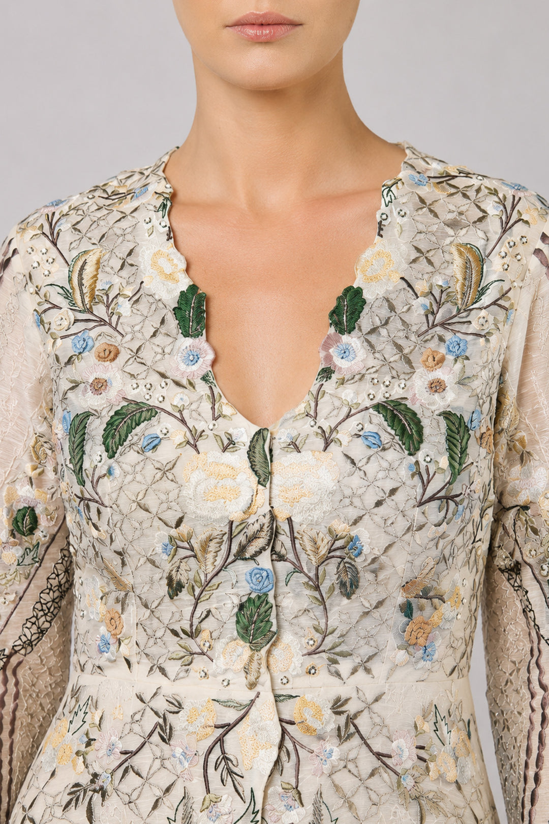 Ivory Embroidered Gown With Pastel Floral Motifs And Elegant V-Neckline.