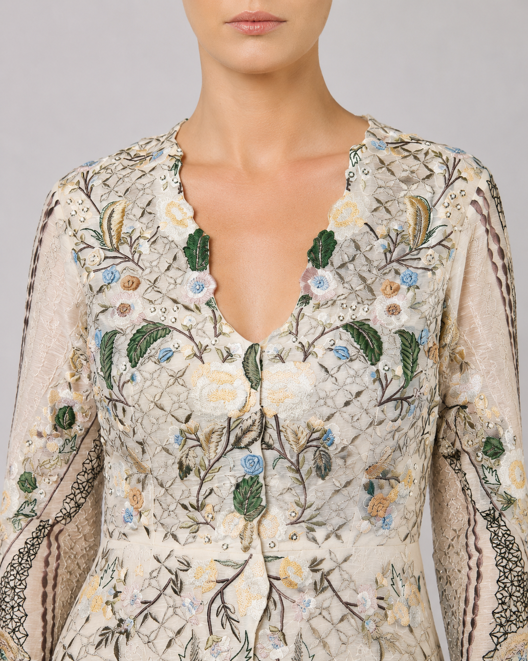 Ivory Embroidered Gown With Pastel Floral Motifs And Elegant V-Neckline.