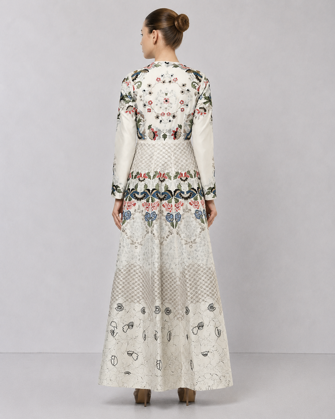 Ivory embroidered gown with artisanal floral motifs and flared silhouette.
