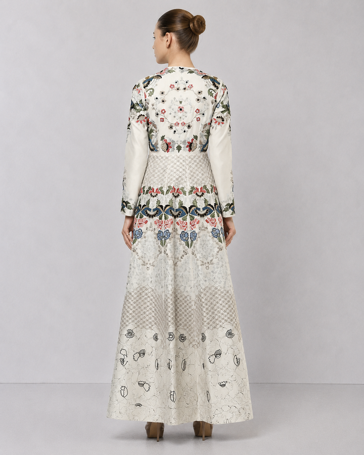 Ivory embroidered gown with artisanal floral motifs and flared silhouette.