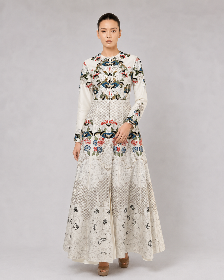 Ivory embroidered gown with artisanal floral motifs and flared silhouette.