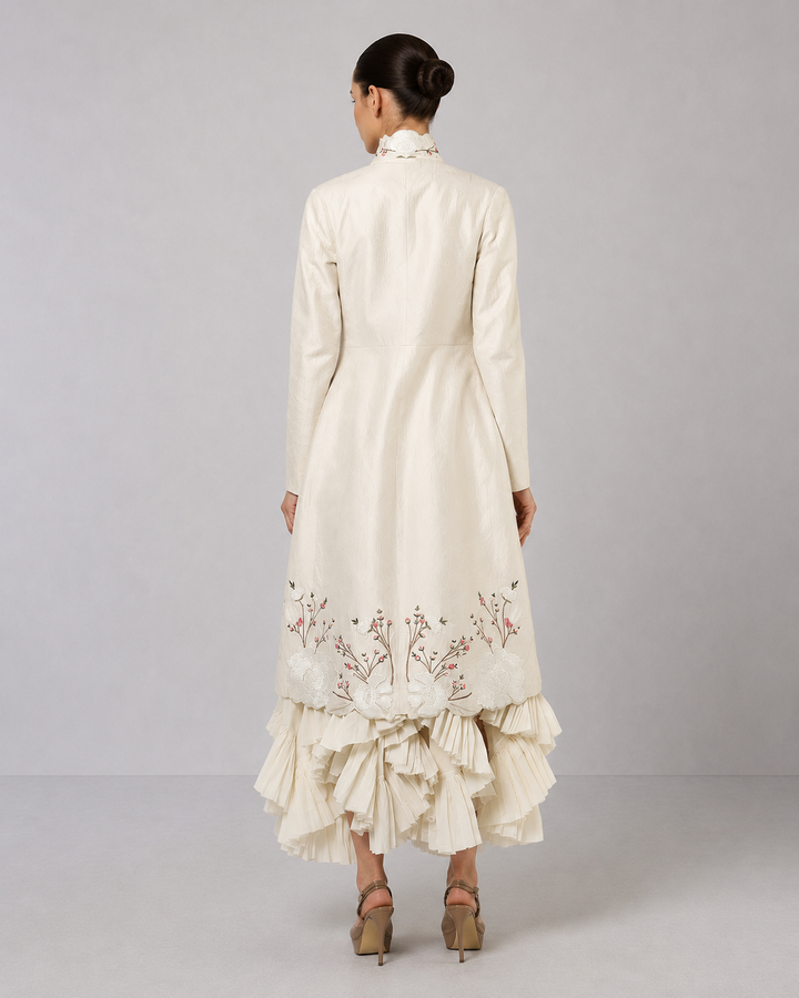 Ivory Layered Dress With Embroidered Jacket And Cascading Pleated Hem.
