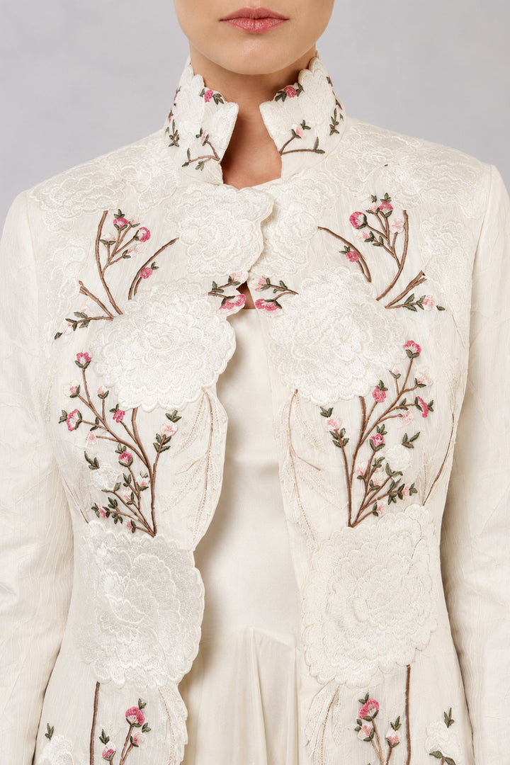 Ivory Layered Dress With Embroidered Jacket And Cascading Pleated Hem.