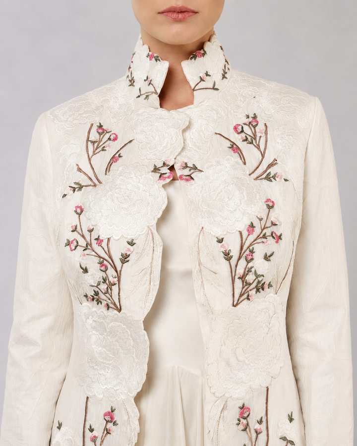 Ivory Layered Dress With Embroidered Jacket And Cascading Pleated Hem.