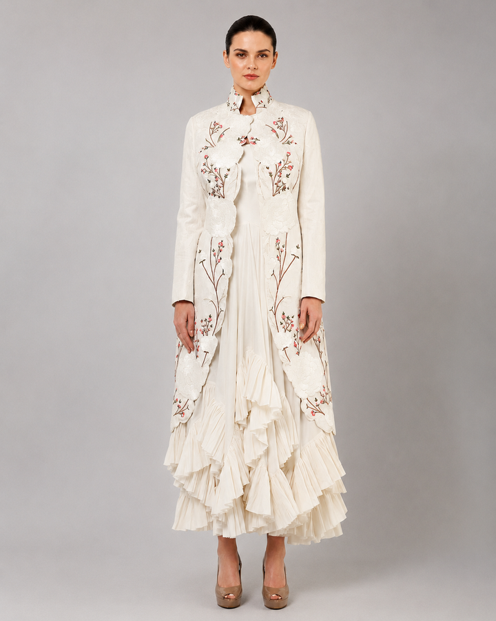 Ivory Layered Dress With Embroidered Jacket And Cascading Pleated Hem.