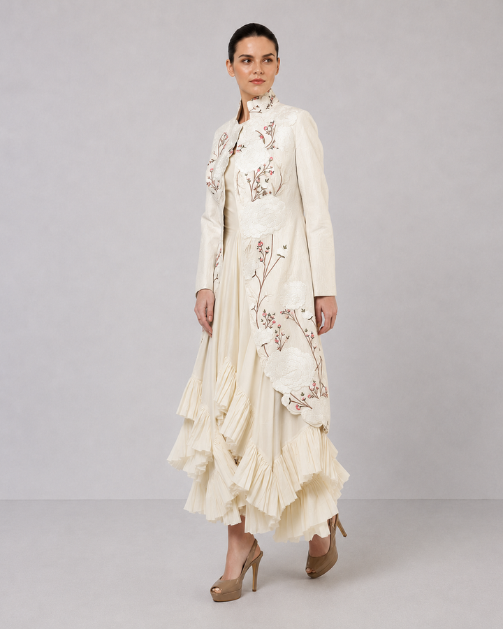 Ivory Layered Dress With Embroidered Jacket And Cascading Pleated Hem.