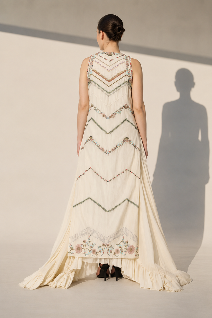 Ivory Embellished Gown With Geometric Embroidery And Flowing Cape Drape.