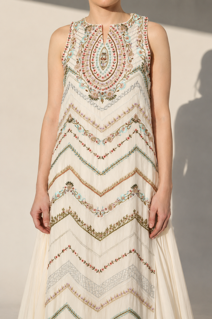 Ivory Embellished Gown With Geometric Embroidery And Flowing Cape Drape.
