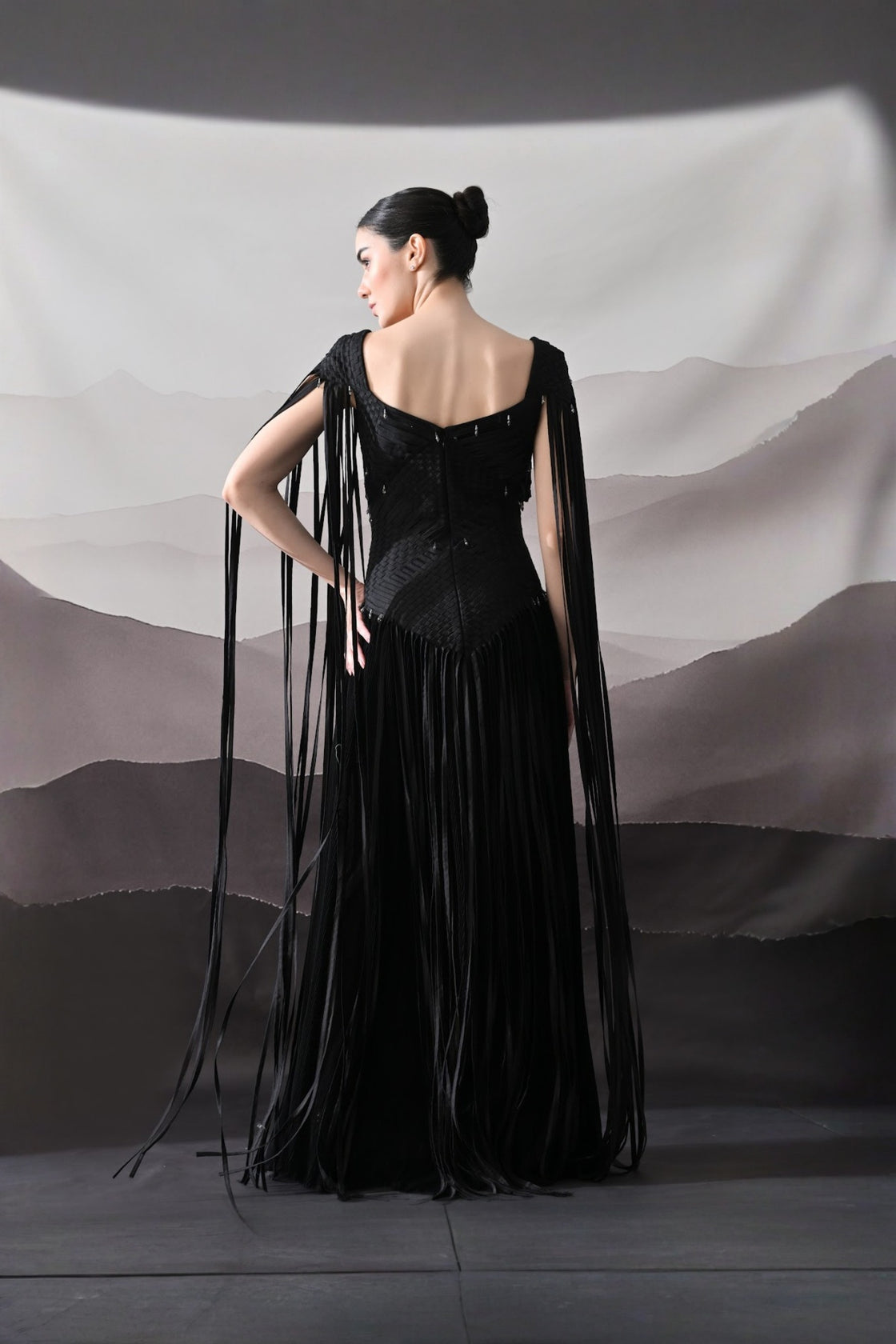 Black Gown With Silhouette Defined By Texture And Movement