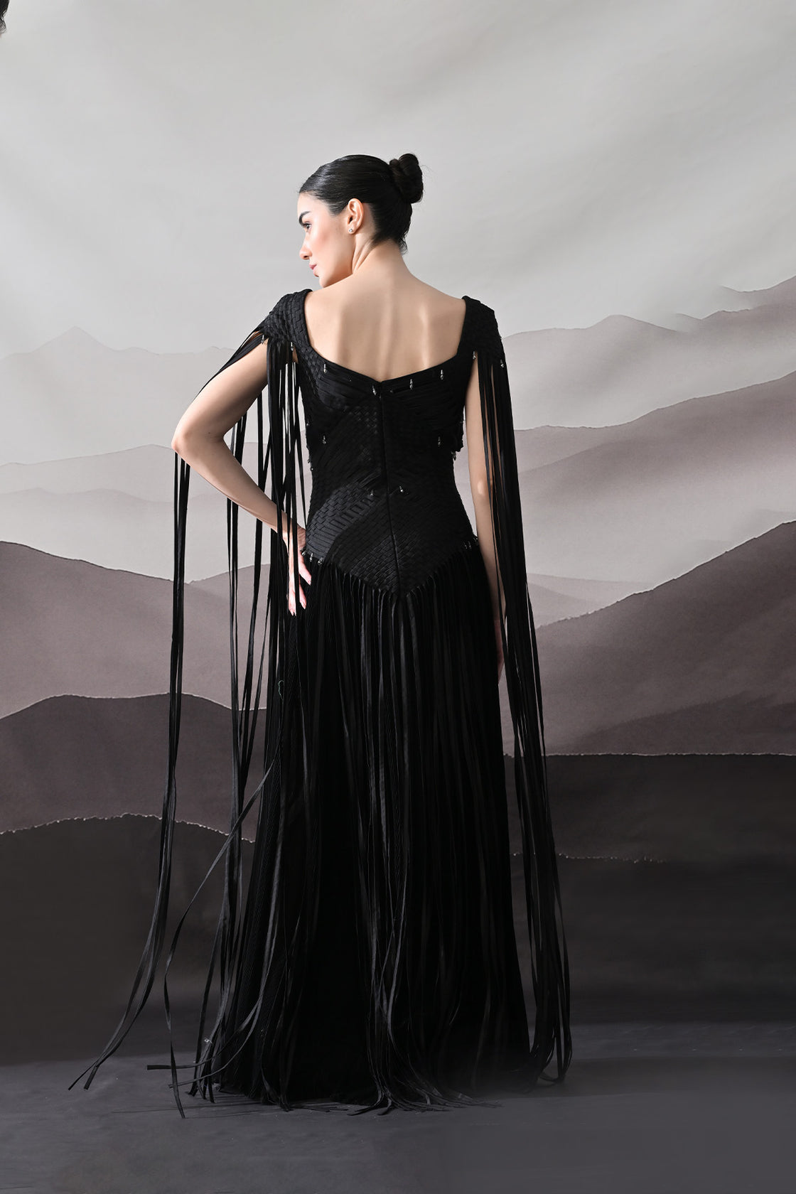 Black Gown With Silhouette Defined By Texture And Movement