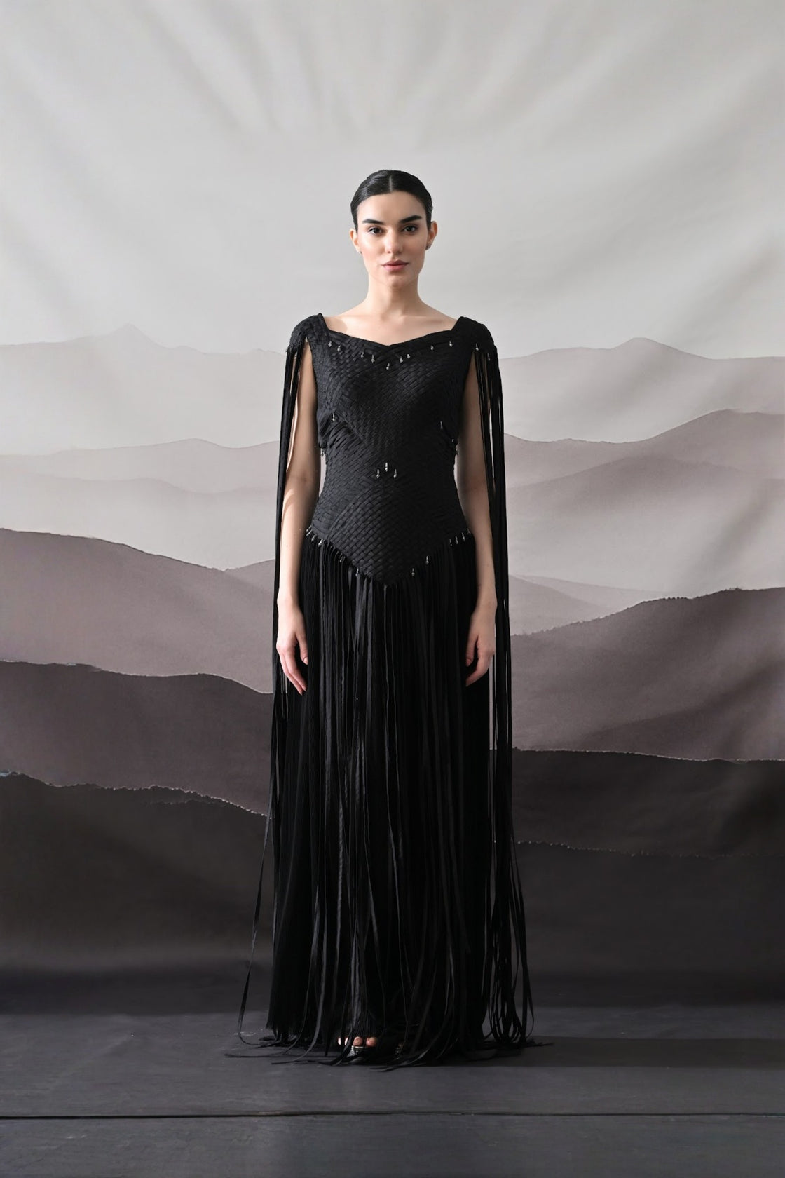 Black Gown With Silhouette Defined By Texture And Movement